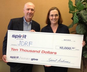 Spirit Airlines' Michael Pewther, who oversees the airline's corporate giving efforts, presents $10,000 to JDRF's Houston Gulf Coast Chapter Executive Director Ms. Naylor.