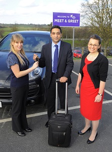 PwC’s Arif Ahmad (C) is greeted by Leeds Bradford Airport’s Car Park Operations Manager Zoe Fisher (L) and Chief Financial Officer Sophie Brown (R) as he drops off his car using the airport’s new meet and greet valet service.