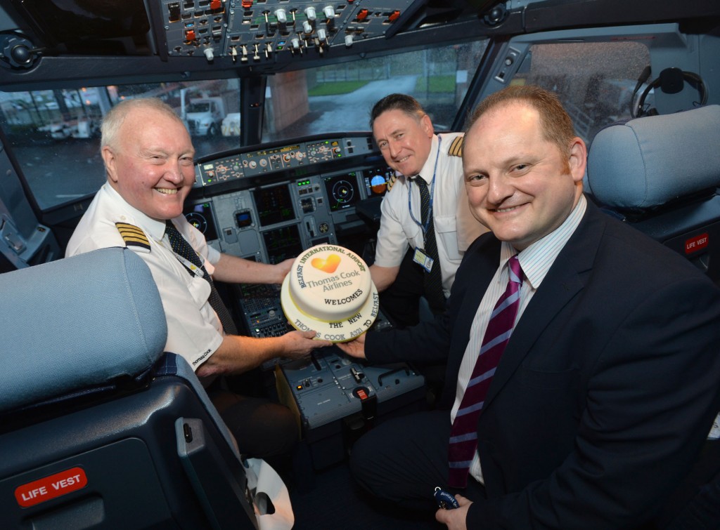 Captain George Carnell and First Officer Andy Queen celebrate the arrival of the new Thomas Cook Airbus A321 aircraft with Uel Hoey, business development director at Belfast International Airport