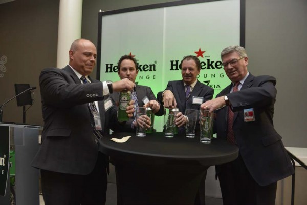 Neil Thompson, HMSHost, Vice President of Canadian Operations (left), Warren Matheos, Regional Director West, Heineken Canada (second from left), Dutch Consul General Johannes Vervloed (second from right) and EIA President and CEO Reg Milley (right) open their giant 710ml cans of Heineken to celebrate the 1st anniversary of the Heineken Lounge at EIA.
