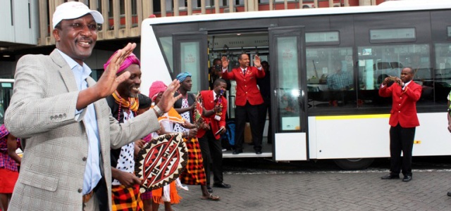 KQ Group CEO, Dr. Titus Naikuni joins traditional dancers in welcoming guests to the new infield shuttle bus 