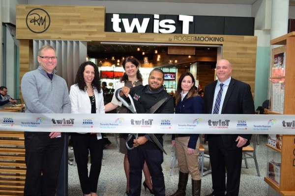 Cutting the ribbon, from left to right: Mike Ross, Director of Commercial Development & Passenger Communications, Greater Toronto Airport Authority; Giovanna Verrilli, Associate Director of Retail and Food Programs, Greater Toronto Airport Authority; Suzanne Merrell, Senior Manager of Food & Beverage Programs, Greater Toronto Airport Authority; Roger Mooking, Chef, Twist; Amy Dunne, Vice President of Business Development, HMSHost; Neil Thompson, Vice President, Canada, HMSHost