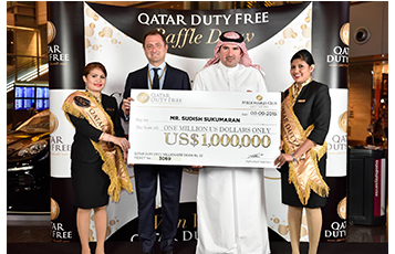 Hamad International Airport’s Vice President Commercial - HIA, Mr Abdulaziz Al Mass (second from right) and Qatar Duty Free’s Vice President of Branded Stores, Mr Luis Gasset (second from left) hold a cheque in the amount of one million USD for Qatar Duty Free’s 20th winner of the Millionaire Draw.