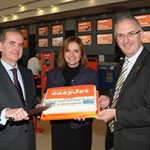 Cutting it in style... easyJet today launched its new route from Belfast International Airport to Birmingham, and there fore the cutting of the celebration cake were John Doran (left), managing director of Belfast International, Ali Gayward, easyJet commercial manager, and Danny Kennedy, Northern Ireland Transport Minister.