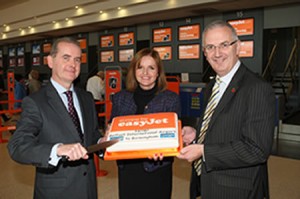 Cutting it in style... easyJet today launched its new route from Belfast International Airport to Birmingham, and there fore the cutting of the celebration cake were John Doran (left), managing director of Belfast International, Ali Gayward, easyJet commercial manager, and Danny Kennedy, Northern Ireland Transport Minister.