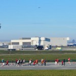 Runners pass the North Airfield Air Traffic Control Tower on the airfield at O'Hare