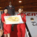 Kenya Airways Flight Attendants Hazel Nzioka and Sonia Sheikh accompanied by Captain Isaac Owino deliver the KQ Msafiri Visa Credit Card from the latest Kenya Airways Embraer E190 jet.