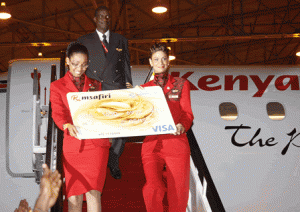 Kenya Airways Flight Attendants Hazel Nzioka and Sonia Sheikh accompanied by Captain Isaac Owino deliver the KQ Msafiri Visa Credit Card from the latest Kenya Airways Embraer E190 jet. 
