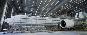 Scaffolding goes up around an Air New Zealand Boeing 777-300ER ahead of installation of the 830 square metre graphic image. 