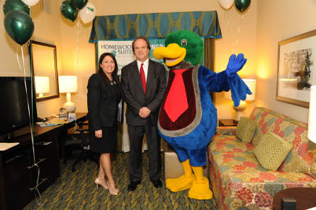 Guest Ken Pope (center) was surprised by Lewis the Duck (right) and Jennifer Hughes, director, brand public relations (left), checking into Homewood Suites by Hilton’s 35,000th suite at the new Homewood Suites Orlando Airport. Credit: Homewood Suites.