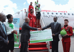 Safaricom CEO, Bob Collymore and Kenya Airways Group Managing Director and CEO, Dr. Titus Naikuni, pose with a dummy air ticket during the launch of  the “Fly with Bonga Points”