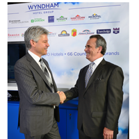 Eric Danziger, president and CEO of Wyndham Hotel Group (r.) and Rob Burns, chief operating officer of The First Group (l.) shake on a deal to bring the first Wyndham Hotels and Resorts hotel to the U.A.E.