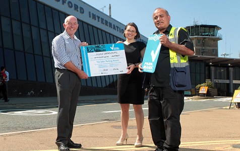 Leeds Bradford Airport’s Chief Financial Officer, Sophie Brown (Centre), and car park team member, Kuldip Mudhar (Right), receive the Park Mark recognition for the eighth year running