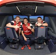 Lukas Podolski, Mesut Özil and Per Mertesacker inside the state of the art A380 flight simulator, at the Emirates Aviation Experience in London.