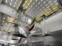 A Boeing 777 is stripped of its exterior paint in the Emirates paint hangar.