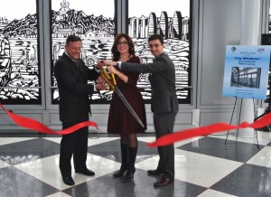 (L-r) Gerald Adelmann, Rosemarie S. Andolino and Andrew Spinelli cut the ribbon for the :City Windows" Chinese paper cut exhibit in Terminal 1 at O'Hare International Airport.