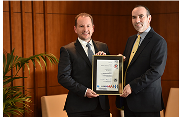 Keith Hunter, QDF Senior Vice President (left) and Nicholas Palmer, QDF Vice President Food and Beverage (right) holding the ISO certificate.