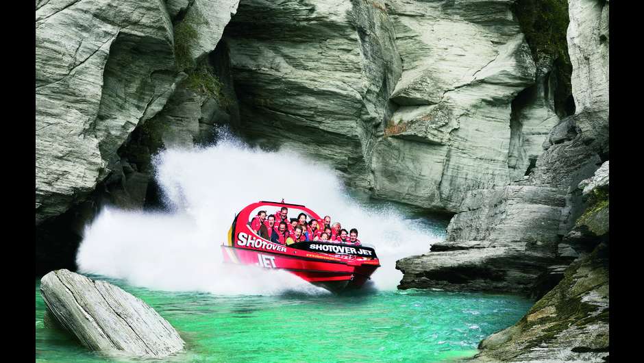 Queenstown’s red Shotover Jet travels through spectacular rocky canyons on a breathtaking high-speed journey. Credit: Shotover Jet / www.shotoverjet.com