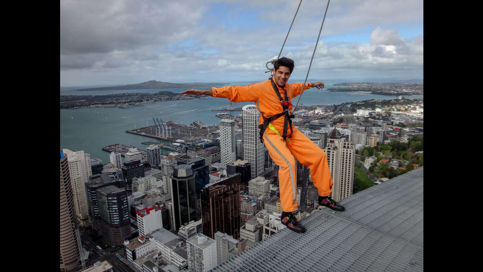 Bollywood superstar Sidharth Malhotra leans out over Auckland City during the Skywalk around the perimeter of the southern hemisphere's tallest building, the Sky Tower.  CREDIT: Camilla Rutherford